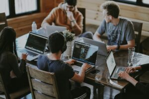 Multiple individuals collaborating with their computers